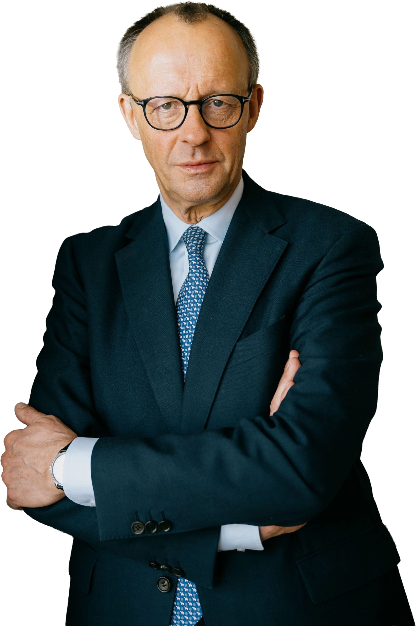 Friedrich Merz, frontally depicted, with glasses and crossed arms in a dark suit.