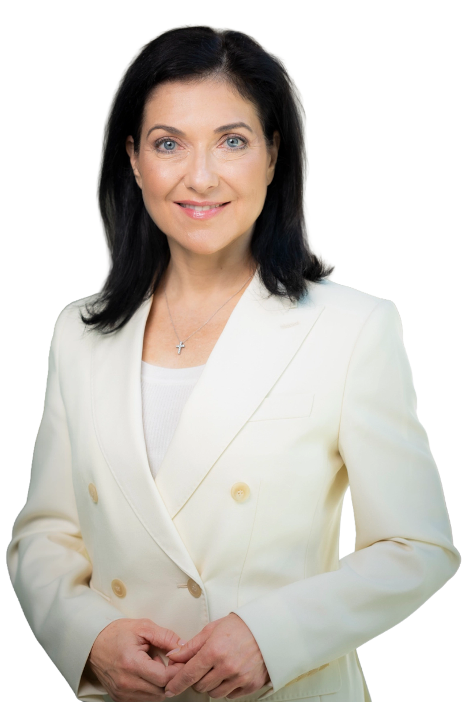 Katherina Reiche, frontally depicted, smiling in a cream blazer, with folded hands.